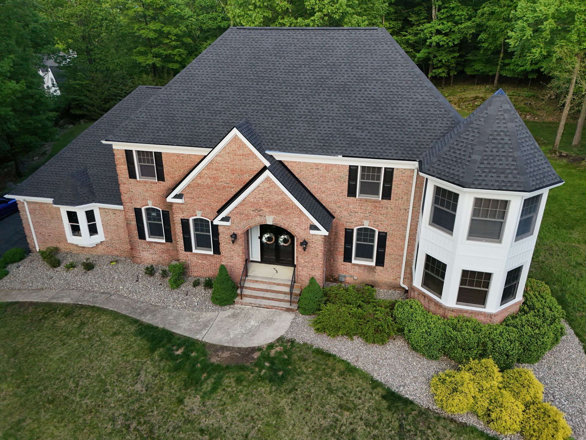 Superior Siding project — Architectural shingle roof · brick colonial · bay turret